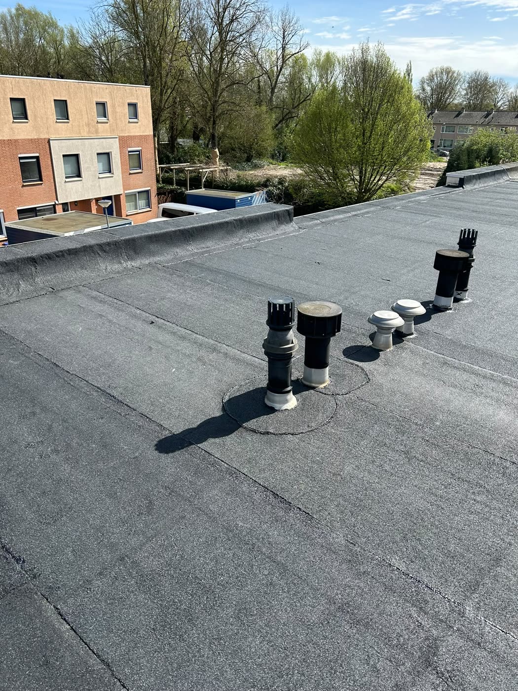 Afgewerkt plat dak met doorvoeren die opnieuw zijn ingewerkt